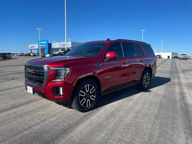 2024 GMC Yukon AT4 in Volcanic Red Tintcoat — front three-quarter view